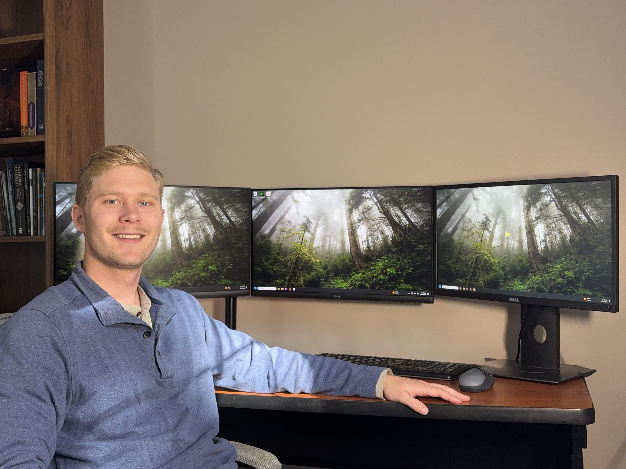 Luke Bousema at his desk in front of three monitors
